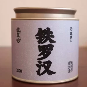 Loose-leaf Tie Luo Han oolong tea, the first of Wuyishan’s Four Famous Bush varieties, showcasing dark twisted leaves and rich aroma.